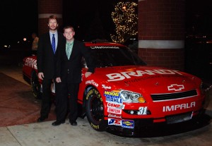 Rick Brandt. left, stands beside the company-sponsored NASCAR Chevrolet Impala, driven by Justin Allgaier.