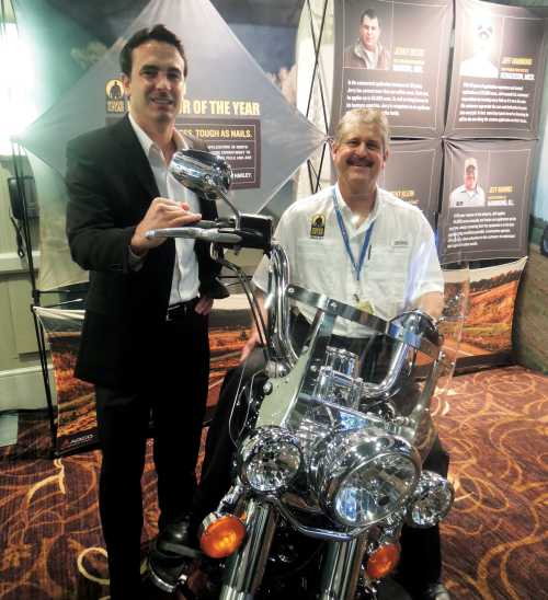 2014 Operator of the Year winner Brent Klein (right) received a new Harley-Davidson motorcycle as AGCO’s 2014 Operator of the Year winner.  With him is Conor Bergin, tactical marketing manager for AGCO Application Equipment. 